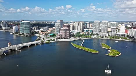 aerial: one flagler, phillips point building and west palm beach cityscape during the day in florida, usa, establishing drone shot