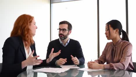 engaging dialogue among colleagues in a modern office setting: a strategic discussion on business initiatives and collaborative solutions