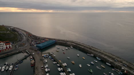 Pullback-Establishing-Drone-Shot-of-Scarborough-Harbour-at-Sunrise-Looking-Out-to-Sea