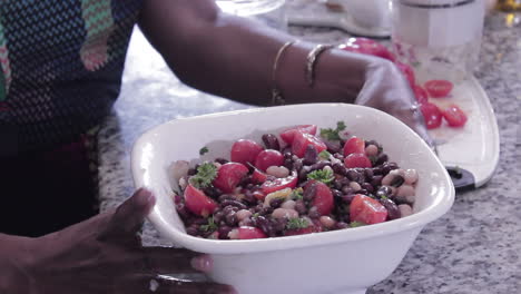 Woman preparing raw bean dish