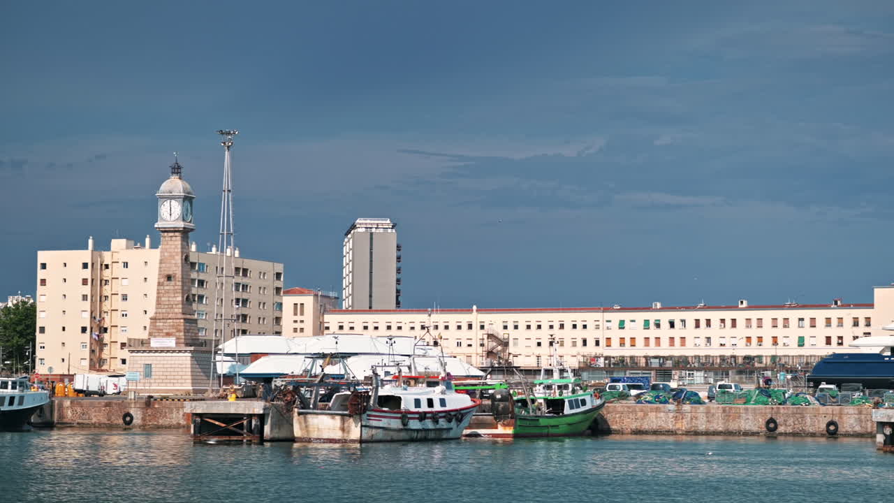Sea port in Barcelona, Spain. Moored yachts, buildings on the background, lighthouse