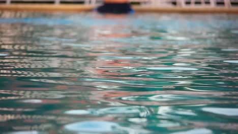 a man swimming towards the camera with a nice depth of field shot