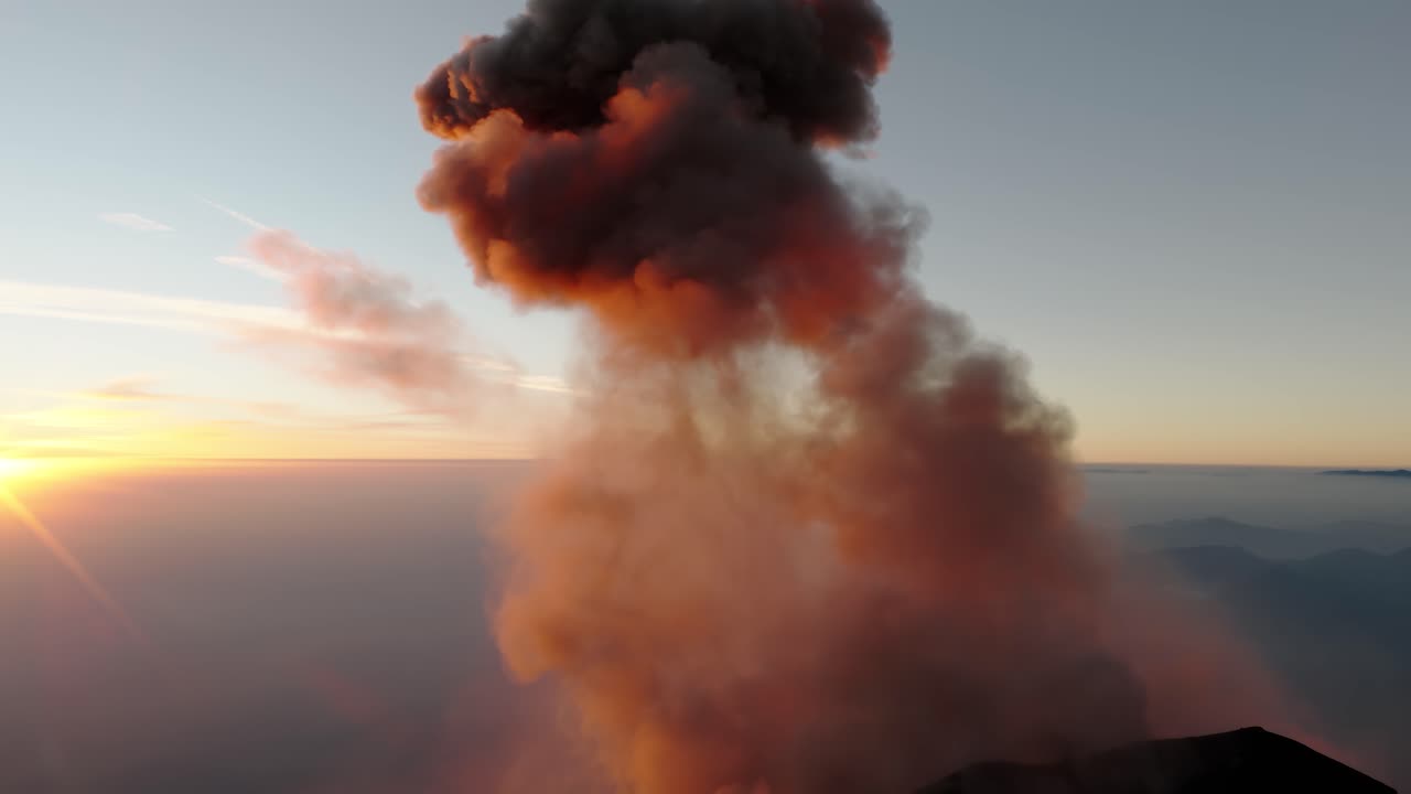 Massive ash plume from Fuego Volcano glowing orange in dramatic Guatemala sunset light