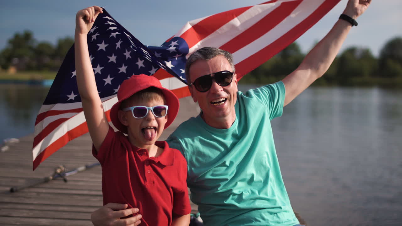 Father and Son Celebrate a Summer Holiday with American Flag