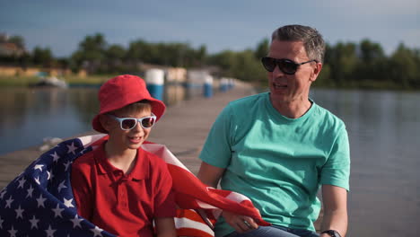father and son celebrate a summer holiday with american flag