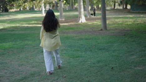 woman walking barefoot in a park