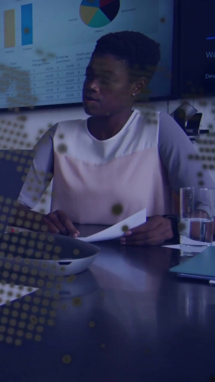Vertical video: Display showing slides, woman holding papers, comparing with business charts