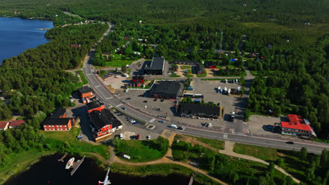 drone tilting away from the inari town, sunny, summer day in lapland, finland