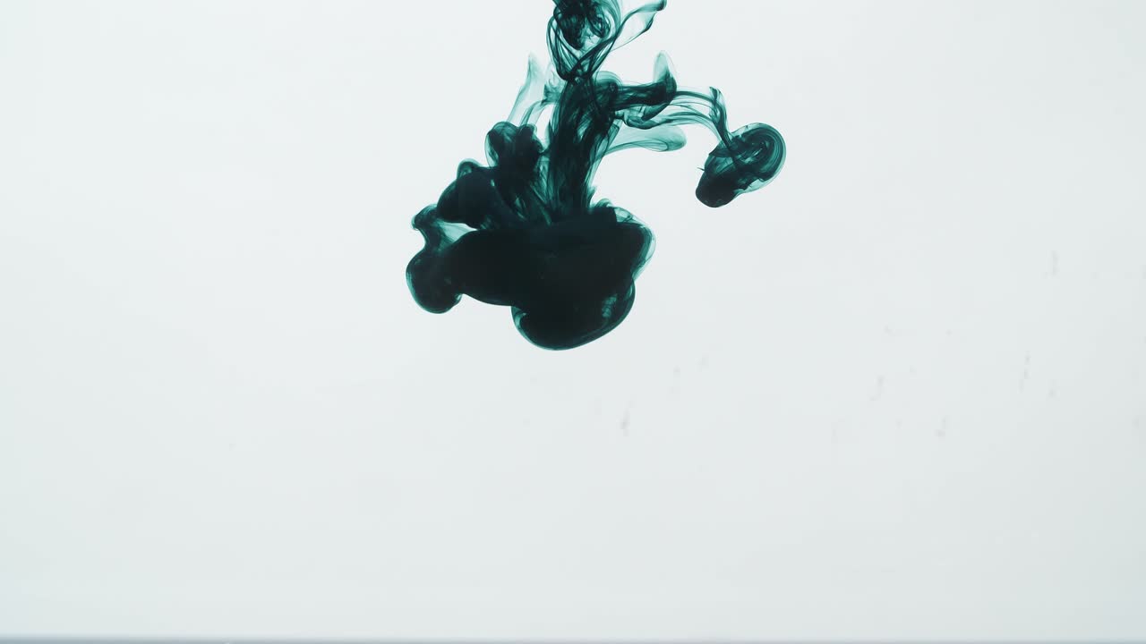 Dark Green Ink Drop Into Water On A White Background