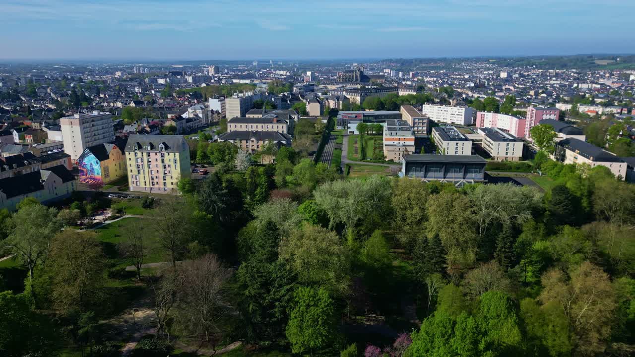 Panorama view of the residential Les Maillets district with apartment blocks and surrounding greenery at Banjan Park, Le Mans, France. Aerial drone flyback