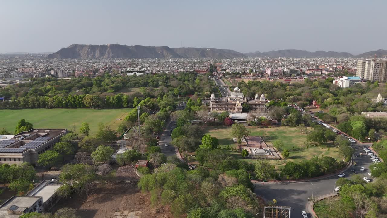 Scenic drone footage of a massive fort wall in the middle of the city Jaipur