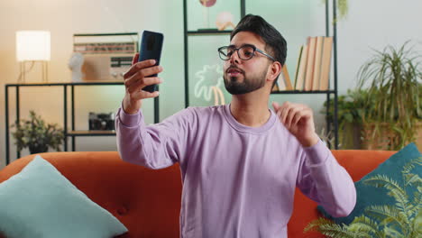 Indian-man-blogger-taking-selfie-on-smartphone-recording-vlog-stories-for-social-media-subscribers