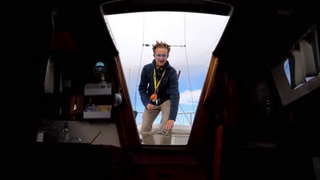 slow-motion-below-deck-shot-of-a-captain-standing-and-speaking-in-the-entrance