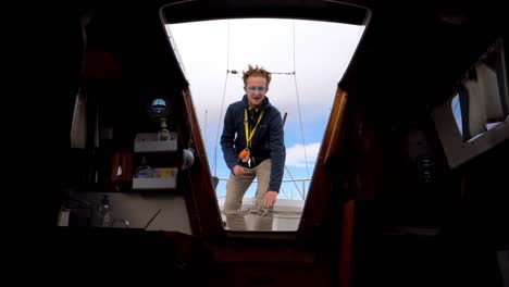 slow motion below deck shot of a captain standing and speaking in the entrance
