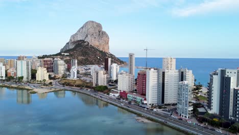 vertical booming aerial record of lake les salines in the foreground and the penyal d'ifac natural park in calp, alicante, spain