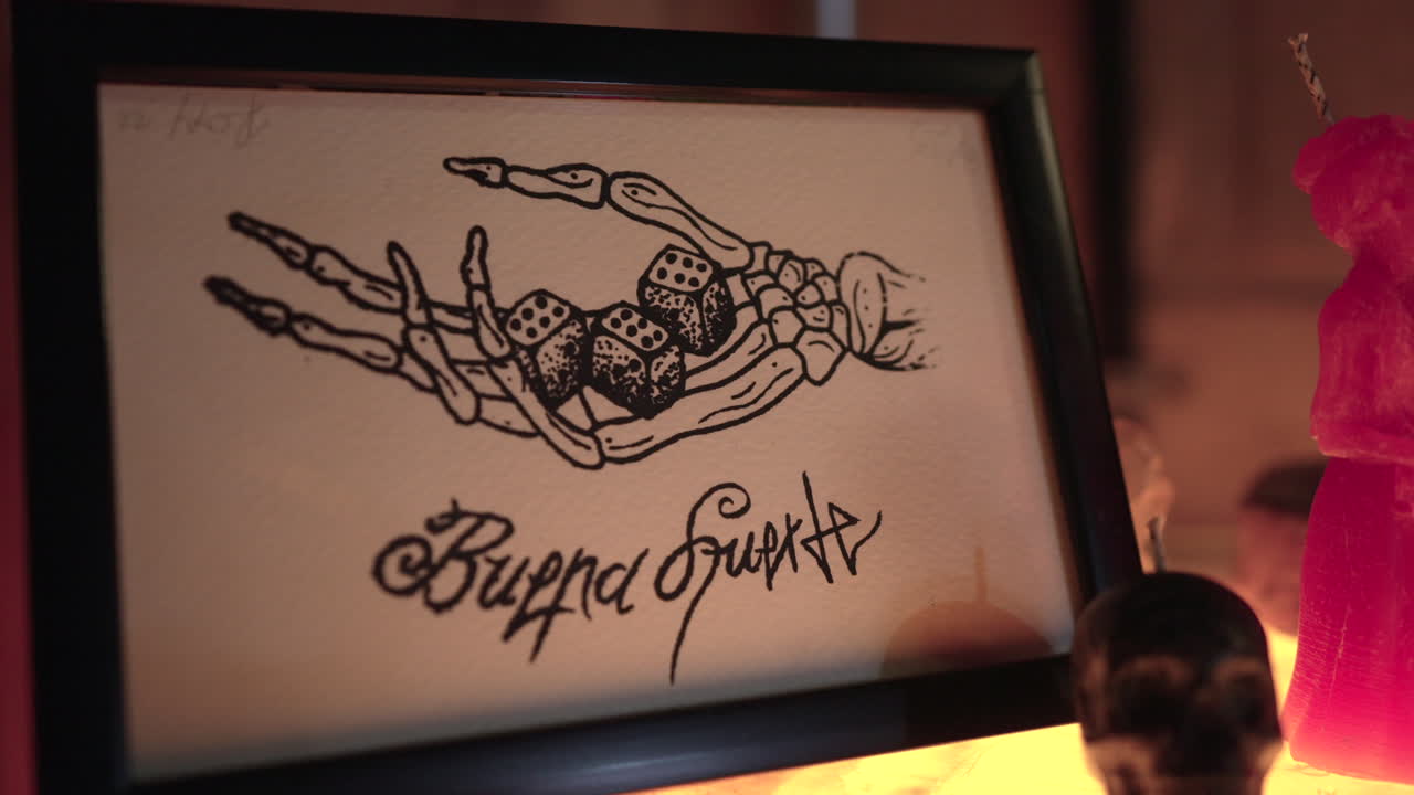 Skeleton Hand Holding Dices On Palm Tattoo Pattern In A Frame At The Tattoo Shop In Sayulita, Mexico