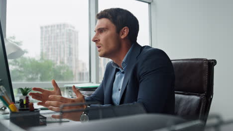 Nervous-businessman-talking-online-shouting-at-computer.-Stressed-tired-manager