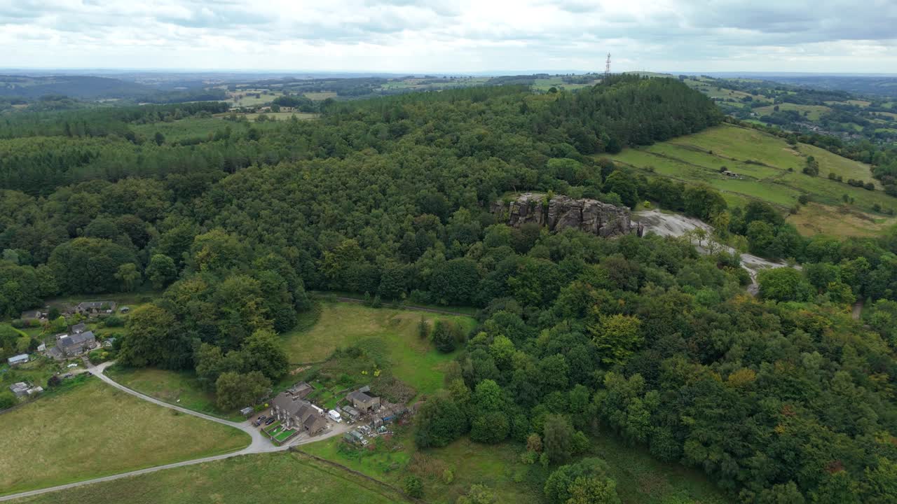 Aerial drone view of Bolehill black rocks hiking trail and mountain with green forest in Derbyshire Dales England UK