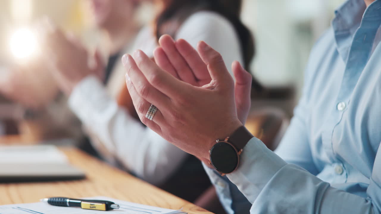 People applauding during a business meeting