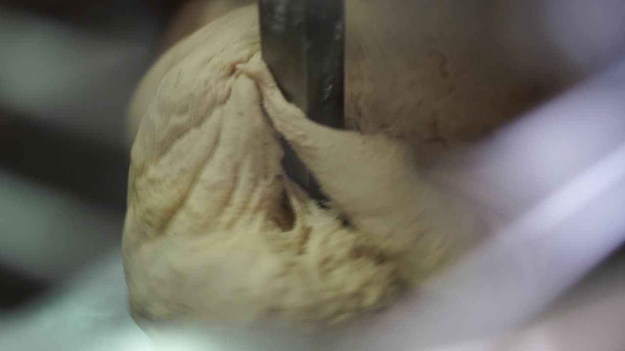 Extreme close-up of bread dough in an industrial mixer