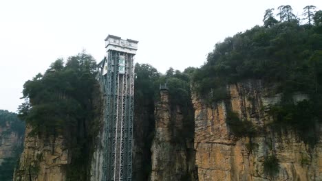 aerial rising shot showing the bailong elevator in zhangjiajie national park