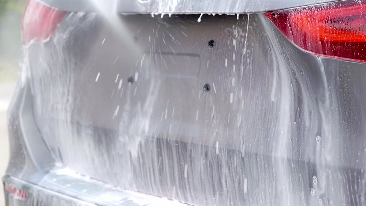 Rinsing snow foam shampoo from SUV boot trunk