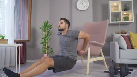 Exercising-at-home.-Young-man-doing-triceps-dips-on-the-couch.