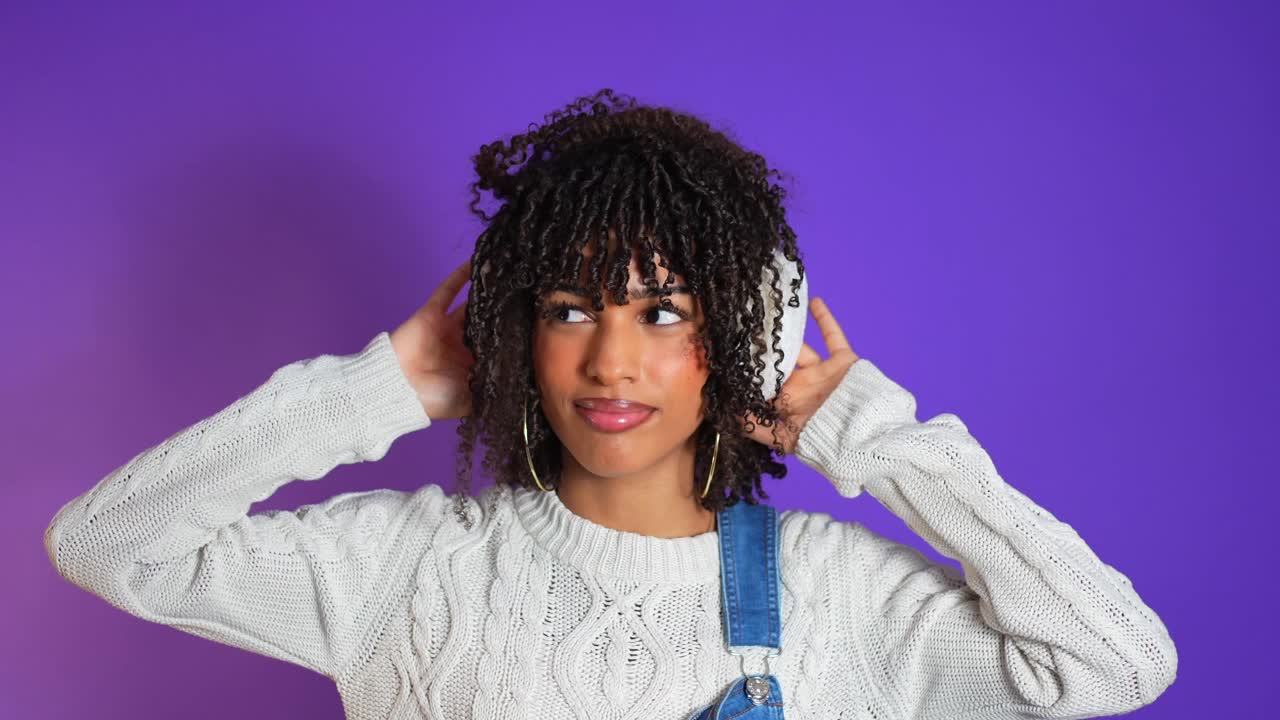 Woman with Headphones on Purple Background