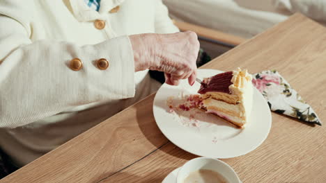 elderly woman eating cake