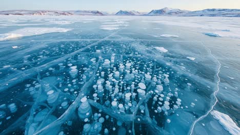stunning aerial view of frozen lake with air bubbles captured beneath the icy surface, highlighting nature's unique phenomena in a serene winter landscape