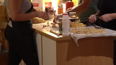 unrecognizable people and friends preparing dinner party in kitchen