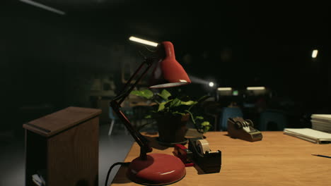 red desk lamp on a wooden desk in a classroom