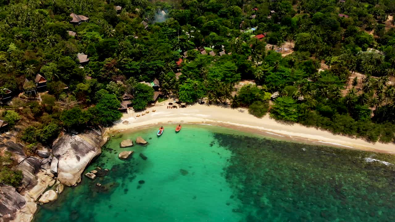 Hovering for an overhead aerial drone shot of Haad Tian beach in the island of Koh Tao in Surat Thani province of Thailand