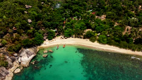 Hovering-for-an-overhead-aerial-drone-shot-of-Haad-Tian-beach-in-the-island-of-Koh-Tao-in-Surat-Thani-province-of-Thailand