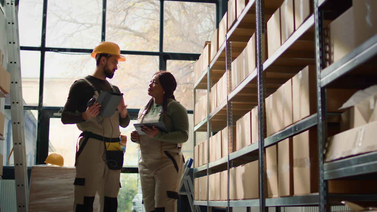 Warehouse employees checking inventory using tablets