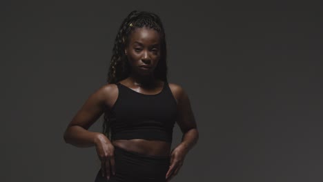 studio portrait of young woman wearing gym fitness clothing for exercise