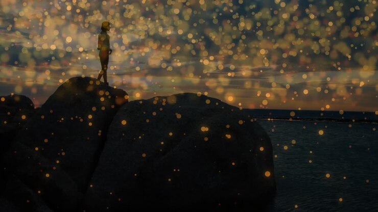 Woman scanning horizon atop boulder as golden bokeh lights drift, creating sunset travel content