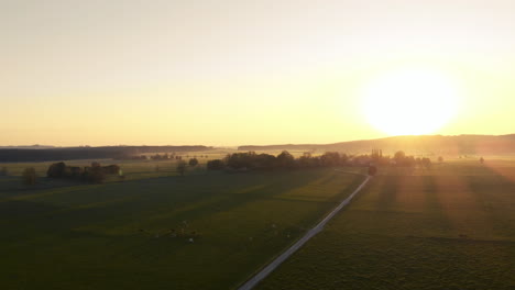 pan over agriculture fields with the sunset over the mountains in the background, bavaria, germany