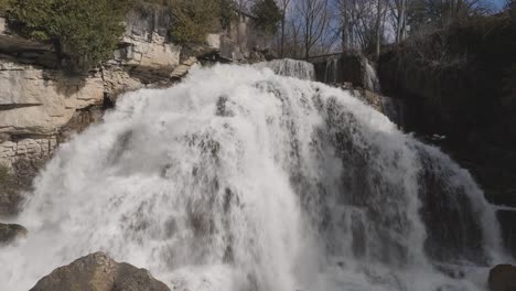 Rushing-waterfall-at-Owen-Sound-with-vigorous-cascades-over-rocky-cliffs,-daytime