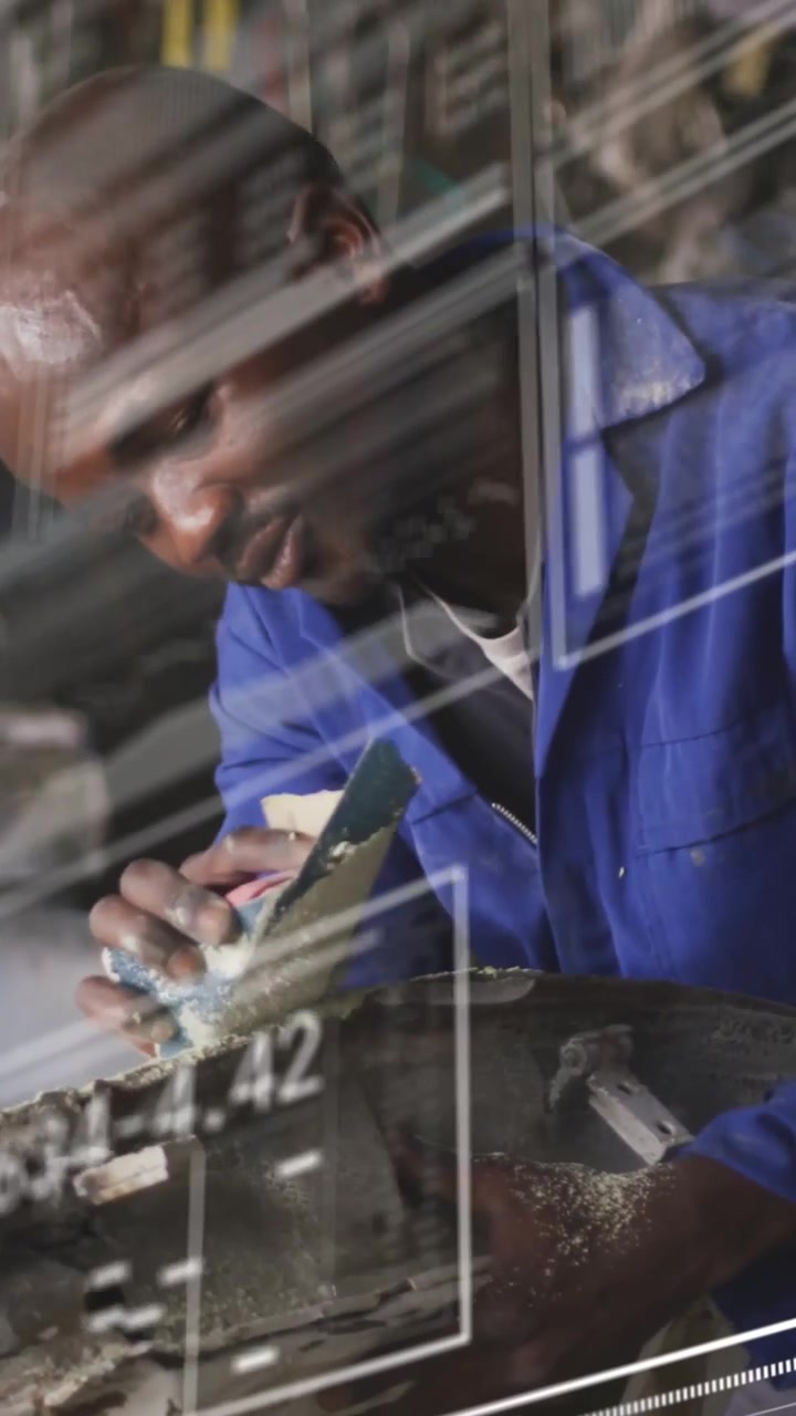 Vertical video: Male tech inspecting rusted metal, sanding and fixing as HUD marking defects
