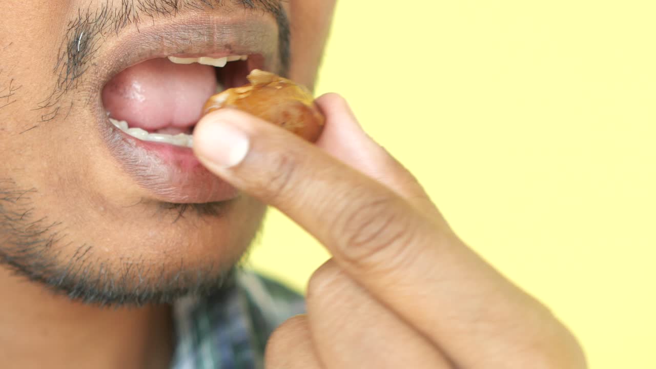A man eats a date