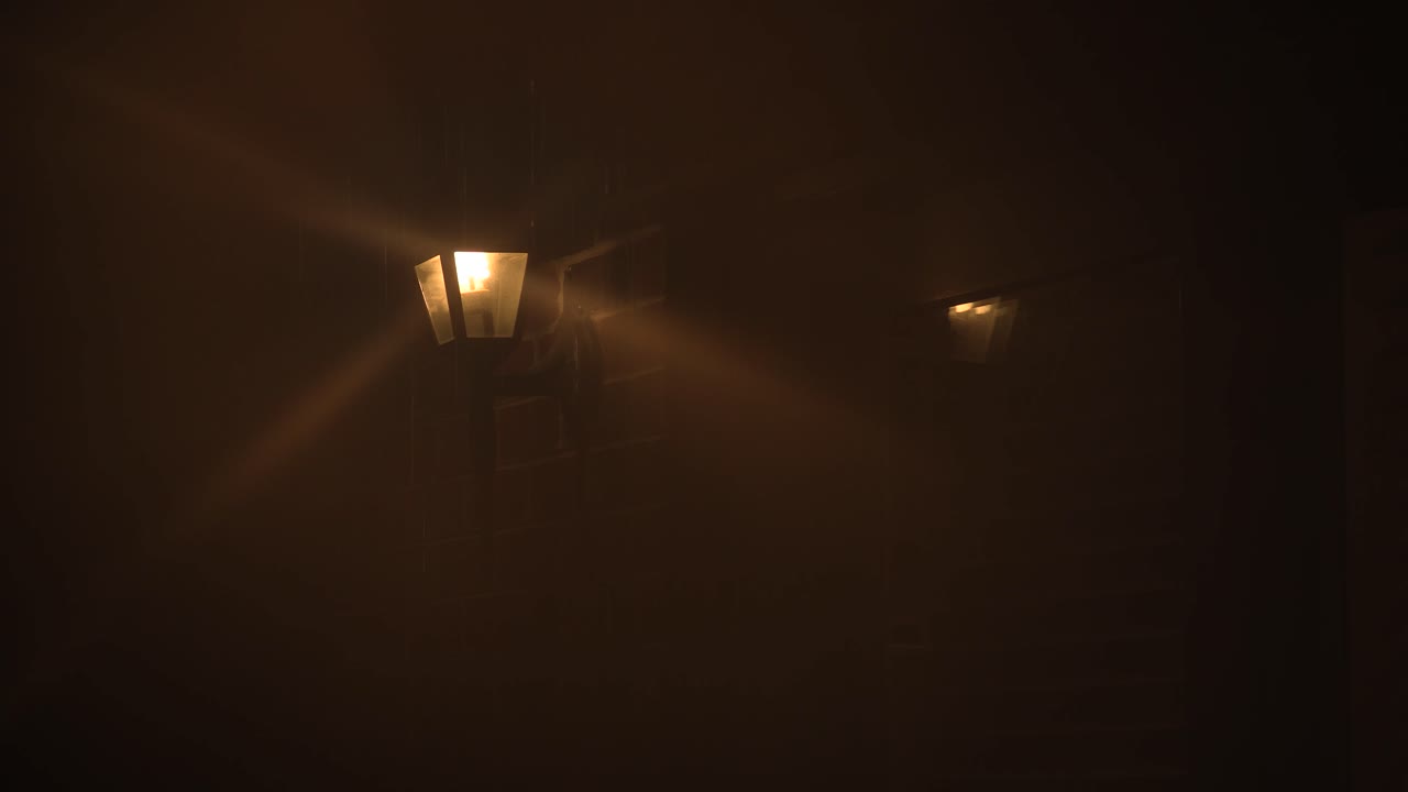 House Lamp Producing Beams of Light in a Rain Storm.