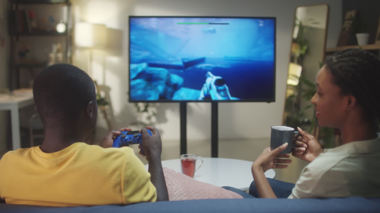 A Couple Playing Video Games in Their Living Room