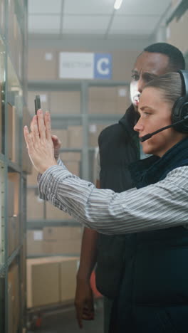 warehouse team inspecting inventory with smartphone