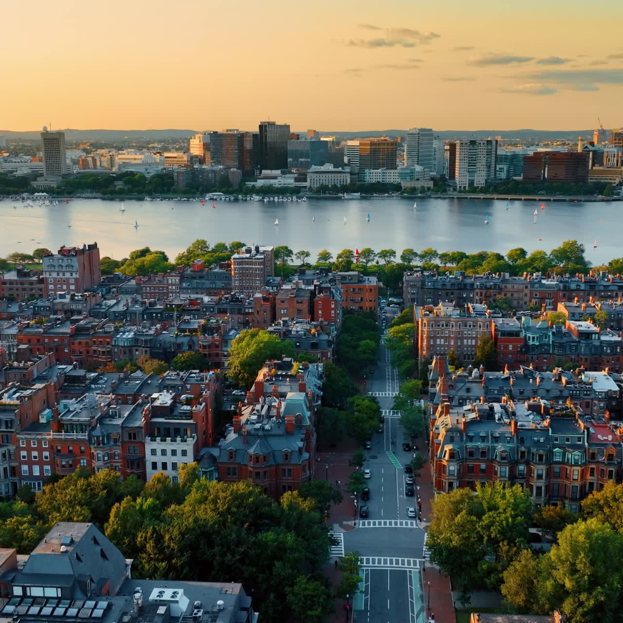 View on the Charles River in Boston flying above the city streets. Residential area built with blocks of flats at the waterfront of the river