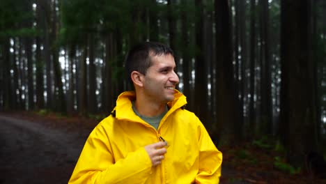 Man-in-forest-smiles-at-camera,-admires-Serra-de-Santa-Barbara