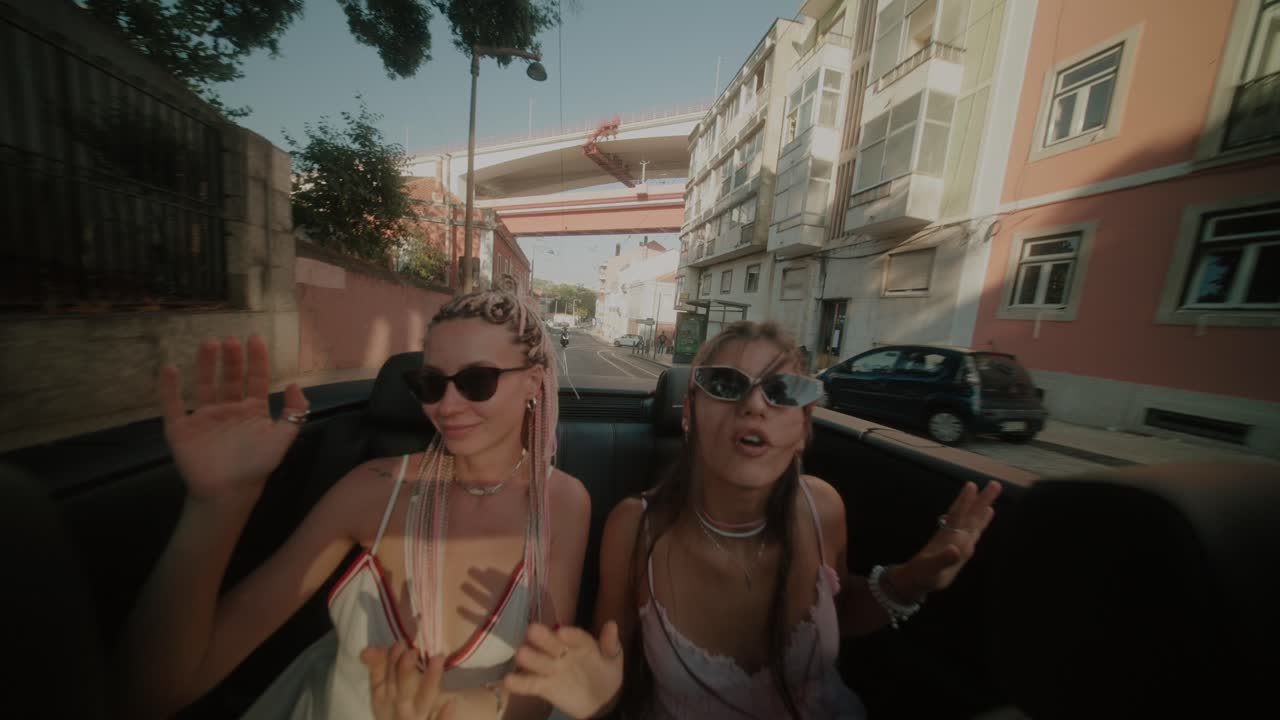 Two women enjoying a sunny day in a convertible