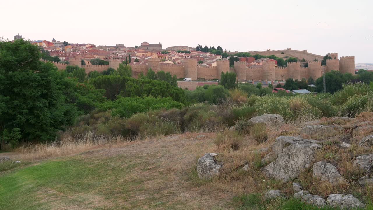 Panoramic landscape shot of Avila, highlighting the old town and its well-preserved medieval walls, recognized as a UNESCO World Heritage Site.
