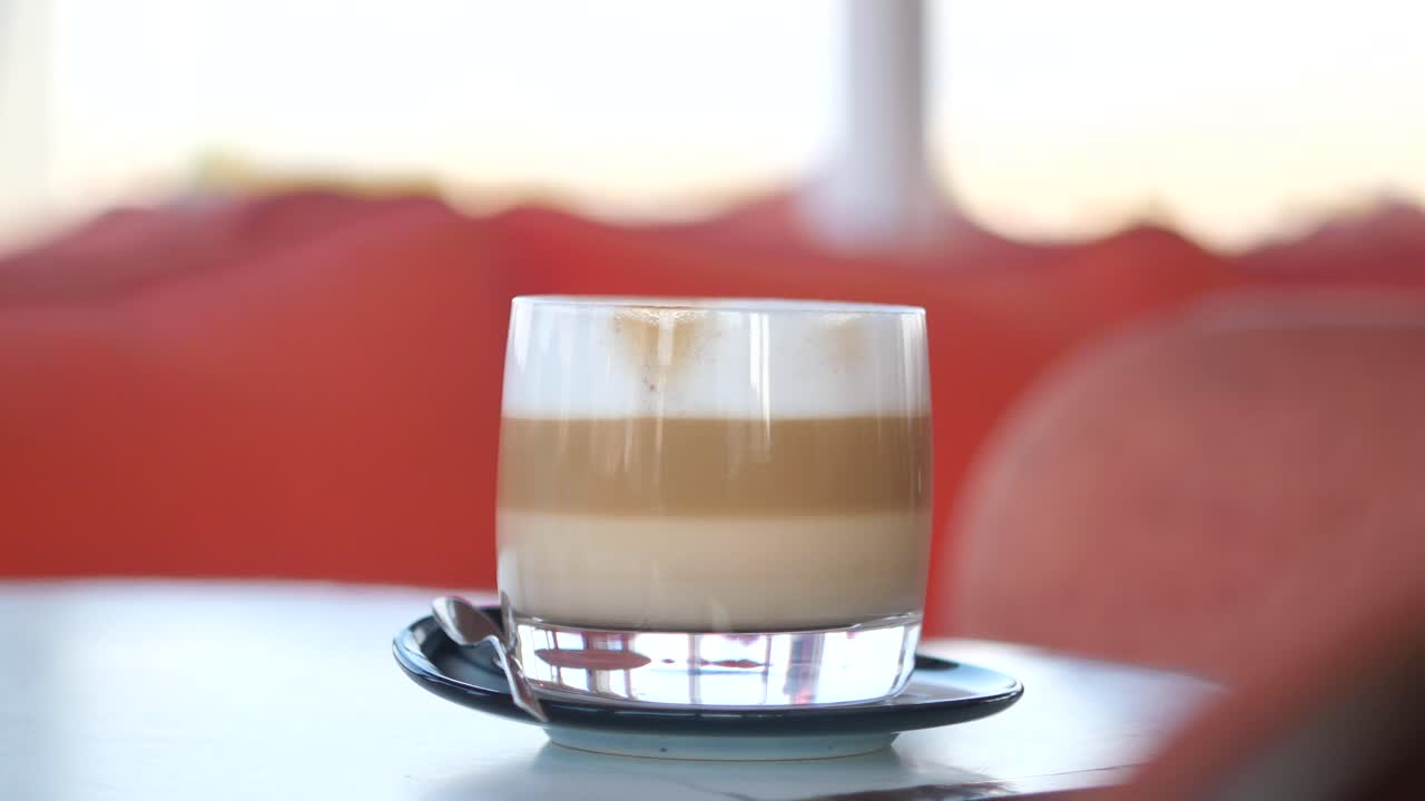 A glass of latte on a table