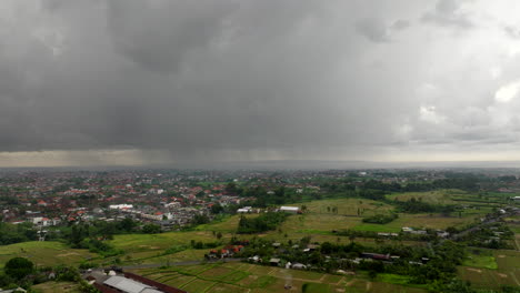 aerial flyback over bali rice fields in indonesia with cloudy stormy sky